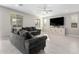 Living room features gray sofas and a large flat-screen TV at 14271 W Alameda Rd, Surprise, AZ 85387