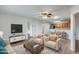 Open living room features hardwood floors, and a view into the kitchen and dining area at 14300 W Bell Rd # 65, Surprise, AZ 85374