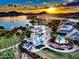 Community pool and clubhouse at sunset, with water features at 17849 W Thistle Landing Dr, Goodyear, AZ 85338