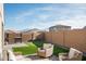 Artificial turf backyard with patio furniture and grill at 17849 W Thistle Landing Dr, Goodyear, AZ 85338