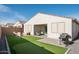 Artificial turf, covered patio, and putting green at 17849 W Thistle Landing Dr, Goodyear, AZ 85338