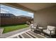 Covered patio with seating area overlooking a grassy backyard at 17849 W Thistle Landing Dr, Goodyear, AZ 85338