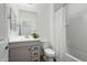Bathroom with gray vanity, toilet, and shower/tub combo at 17849 W Thistle Landing Dr, Goodyear, AZ 85338