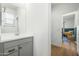 Modern bathroom with gray vanity and a view of a bedroom at 17849 W Thistle Landing Dr, Goodyear, AZ 85338