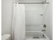Clean bathroom with a shower/tub combo and white tile at 17849 W Thistle Landing Dr, Goodyear, AZ 85338