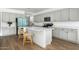 Modern kitchen with island, gray cabinets, and quartz countertops at 17849 W Thistle Landing Dr, Goodyear, AZ 85338