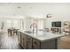 Open concept kitchen features a large island and white quartz countertops at 17849 W Thistle Landing Dr, Goodyear, AZ 85338
