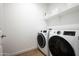 Laundry room with washer and dryer, and additional shelving at 17849 W Thistle Landing Dr, Goodyear, AZ 85338
