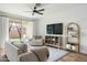 Spacious living room with comfortable seating and backyard access at 17849 W Thistle Landing Dr, Goodyear, AZ 85338