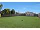 Spacious backyard with a grassy lawn and block fence at 2042 E Aire Libre Ave, Phoenix, AZ 85022
