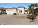 Single-story house with a two-car garage and desert landscaping at 2042 E Aire Libre Ave, Phoenix, AZ 85022