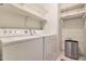Laundry room with washer, dryer, and ample shelving at 2042 E Aire Libre Ave, Phoenix, AZ 85022