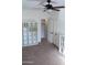 Bright bedroom with carpet, ceiling fan, and built-in shelving at 25696 W Williams Ct, Buckeye, AZ 85326