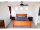 Bright bedroom with a queen bed, ceiling fan, and sliding door to a private balcony at 25696 W Williams Ct, Buckeye, AZ 85326