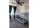 Bedroom with bunk beds and dinosaur poster at 25696 W Williams Ct, Buckeye, AZ 85326