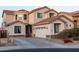 Two-story house with a large garage and nicely landscaped front yard at 25696 W Williams Ct, Buckeye, AZ 85326