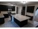 Open kitchen features an island, granite countertops, and dark cabinetry at 25696 W Williams Ct, Buckeye, AZ 85326