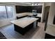 Spacious kitchen with island, granite countertops, and dark cabinetry at 25696 W Williams Ct, Buckeye, AZ 85326