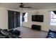 Living room features a large TV and access to backyard at 25696 W Williams Ct, Buckeye, AZ 85326