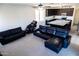 Open living room with a sectional sofa and view into the kitchen at 25696 W Williams Ct, Buckeye, AZ 85326