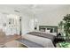 Staged bedroom featuring a green headboard, neutral bedding, stylish decor, and en-suite bathroom at 4540 N 44Th St # 41, Phoenix, AZ 85018