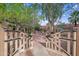 Charming courtyard entrance with mature trees, a decorative gate, and inviting walkway at 4540 N 44Th St # 41, Phoenix, AZ 85018
