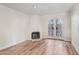 Bright living room features wood floors, a cozy fireplace, and double doors to the patio at 4540 N 44Th St # 41, Phoenix, AZ 85018
