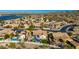 Aerial view of houses with pools and solar panels near a lake and mountains at 10812 S Coolwater Dr, Goodyear, AZ 85338