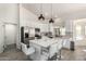 Modern kitchen with white cabinets, stainless steel appliances and large island at 10812 S Coolwater Dr, Goodyear, AZ 85338