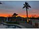 Sunset view of a backyard pool, lounge chairs, and a mountain view at 10812 S Coolwater Dr, Goodyear, AZ 85338