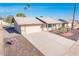 Single story home with a light beige exterior, landscaping, and a 2 car garage at 13502 W Hyacinth Dr, Sun City West, AZ 85375