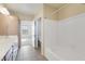 Bright bathroom with double sink vanity, storage, and bathtub with shower at 14575 W Mountain View Blvd # 11317, Surprise, AZ 85374