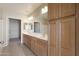 Bathroom features double sink vanity, cabinetry, and a door into the walk-in closet at 14575 W Mountain View Blvd # 11317, Surprise, AZ 85374