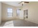 Spacious carpeted bedroom with a ceiling fan and plenty of natural light at 14575 W Mountain View Blvd # 11317, Surprise, AZ 85374
