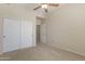 Bedroom with a ceiling fan and sliding closet doors at 14575 W Mountain View Blvd # 11317, Surprise, AZ 85374