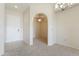Inviting entryway with arched doorway, tile floors, and modern lighting fixture at 14575 W Mountain View Blvd # 11317, Surprise, AZ 85374