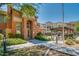 Beautiful condo building with manicured landscaping and walkway leading to a pool area at 14575 W Mountain View Blvd # 11317, Surprise, AZ 85374
