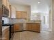 Kitchen boasts stainless steel appliances, tile backsplash, and granite countertops at 14575 W Mountain View Blvd # 11317, Surprise, AZ 85374
