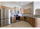 Bright kitchen features stainless steel appliances, tile backsplash, and granite countertops at 14575 W Mountain View Blvd # 11317, Surprise, AZ 85374