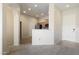 Open living room with an arched doorway leading to the kitchen area at 14575 W Mountain View Blvd # 11317, Surprise, AZ 85374