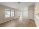 Spacious living area featuring wood-look floors and large windows at 15455 S Williams Pl, Arizona City, AZ 85123