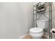 Small bathroom with toilet and shelving unit at 16 W Encanto Blvd # 609, Phoenix, AZ 85003