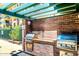 Outdoor grill area featuring stainless steel grills, brick surround, and a metal pergola overhead at 16 W Encanto Blvd # 609, Phoenix, AZ 85003