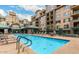 Community pool featuring ample lounge seating and shaded areas, set against a multi-story residential building at 16 W Encanto Blvd # 609, Phoenix, AZ 85003