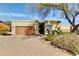 Single-story home with a two-car garage and mature trees at 18626 E Amarado Cir, Rio Verde, AZ 85263