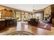 Open concept kitchen and living area with a stone fireplace at 18626 E Amarado Cir, Rio Verde, AZ 85263