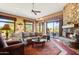 Spacious living room with a stone fireplace and patio access at 18626 E Amarado Cir, Rio Verde, AZ 85263