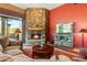 Cozy living room with a stone fireplace and large screen TV at 18626 E Amarado Cir, Rio Verde, AZ 85263
