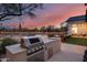 Outdoor kitchen with built-in grill, adjacent to pool and patio at 23653 N 80Th Way, Scottsdale, AZ 85255