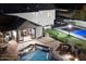 Night view of a home with pool and sports court at 30017 N 60Th St, Cave Creek, AZ 85331